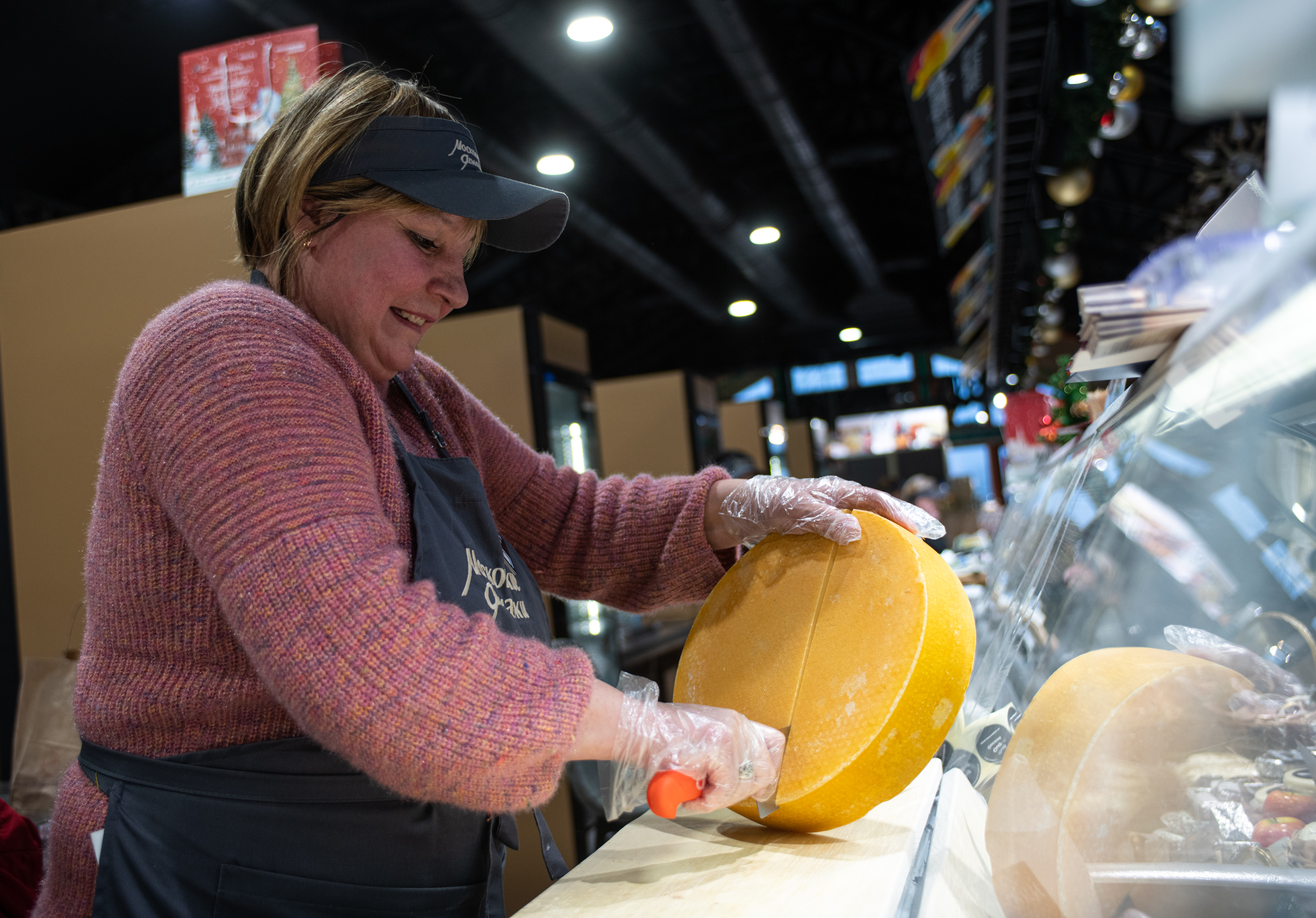 Сырная ярмарка на Святоозерской улице. Продавец Елена Данилова обслуживает очередного покупателя, который к праздничному новогоднему столу решил приобрести продукцию отечественных фермеров