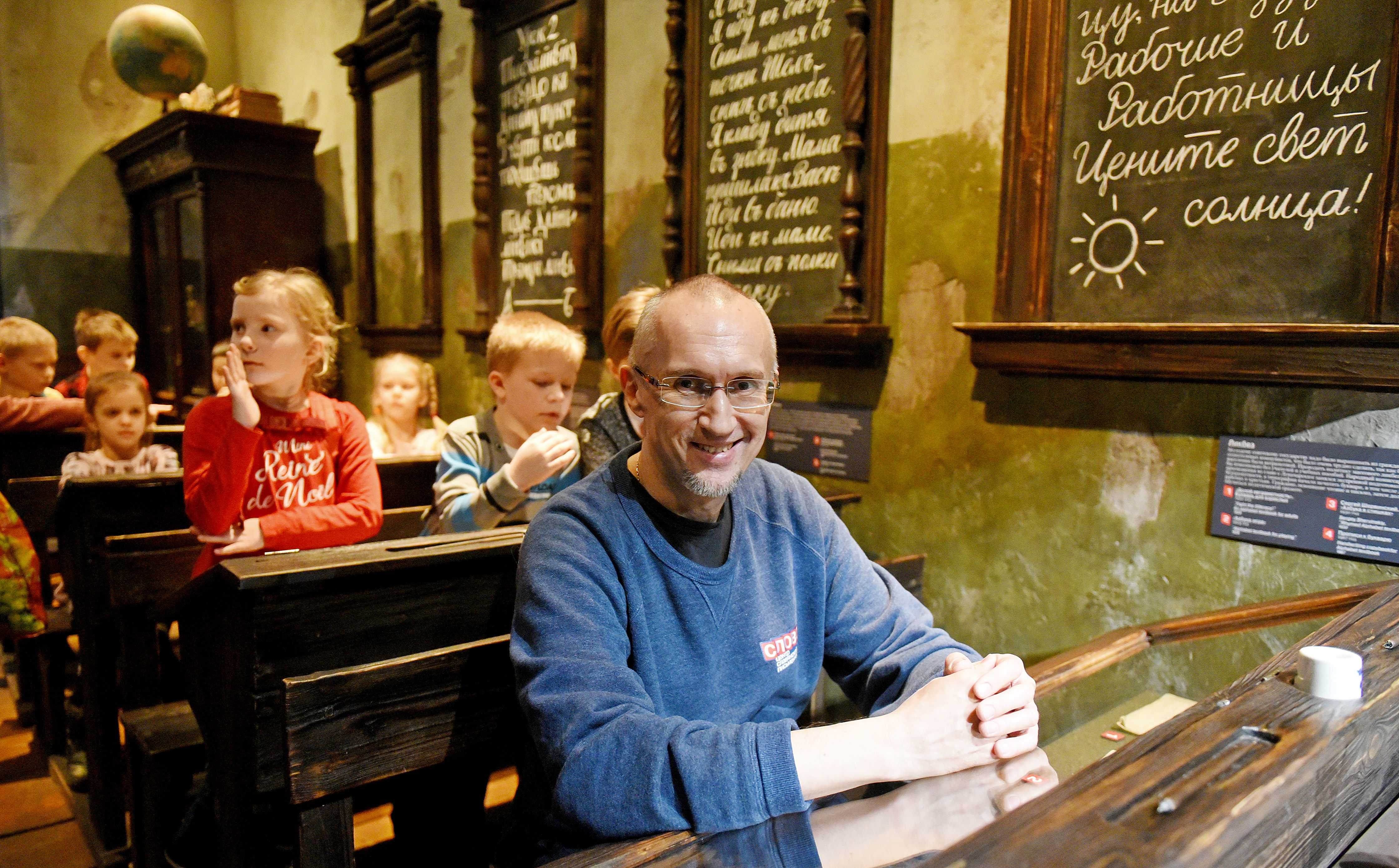 Экскурсовод Центра славянской письменности «Слово» Дмитрий Тараторин показал учебный класс со старинными деревянными партами и учебниками разных времен