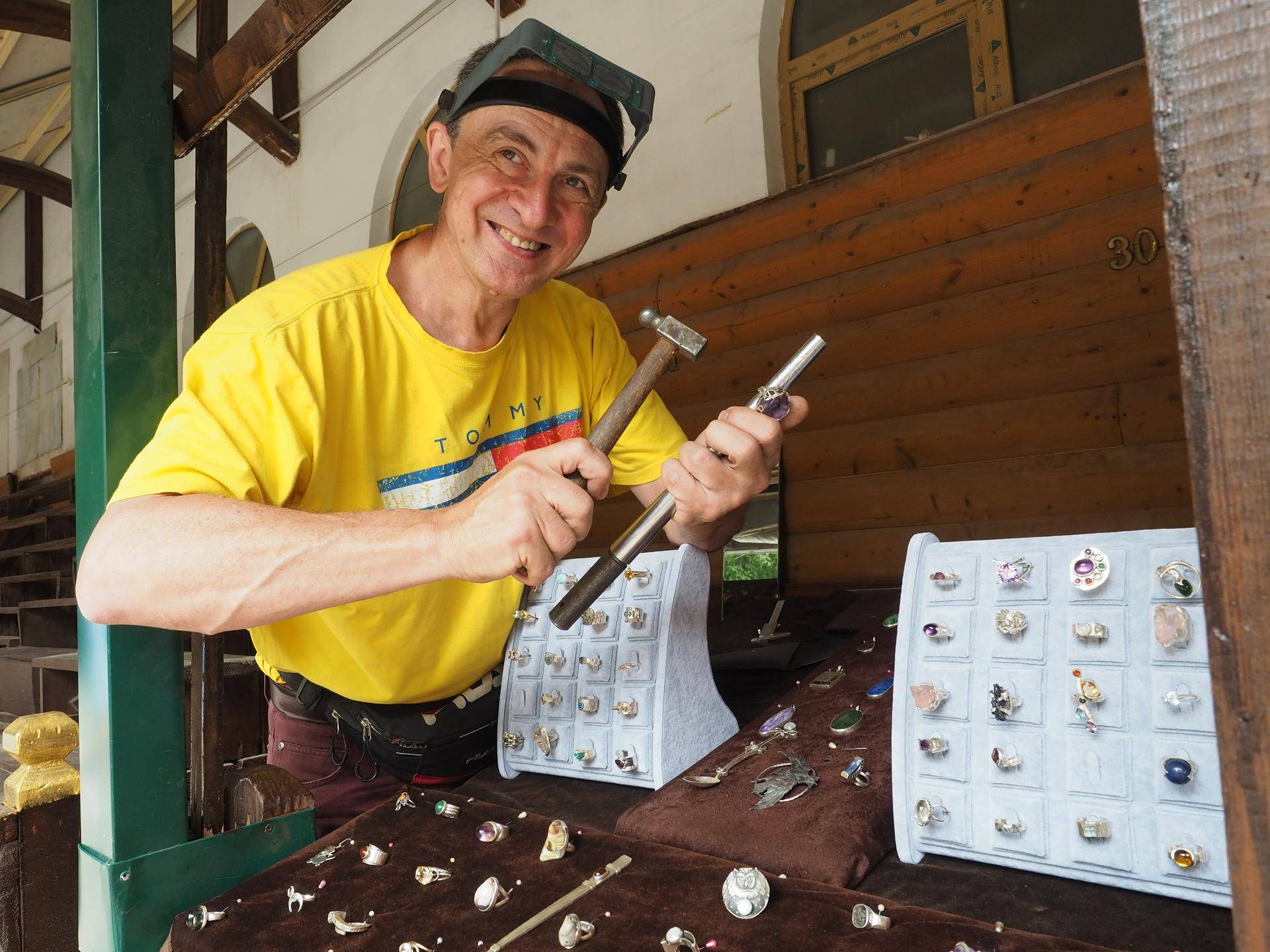 Ювелир Сергей Казаков увеличивает размер изготовленного им же кольца. Он уверяет, что его украшения стали покупать чаще, а вот случайных посетителей стало меньше