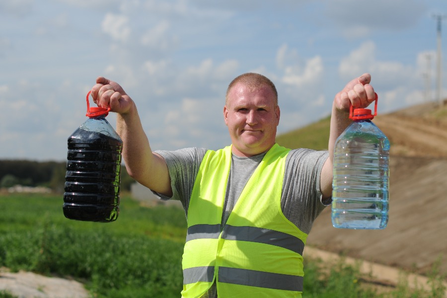 Начальник участка по очистным сооружениям Сергей Лосев показывает разницу до и после фильтрации воды, которая поступает в специальный резервуар с полигона Кучино
