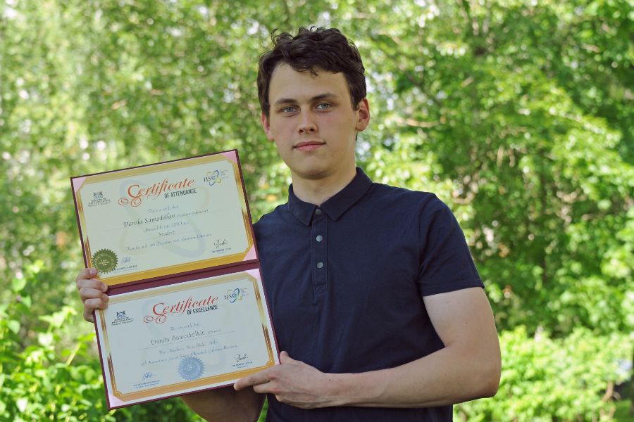 Победитель Азиатской олимпиады по физике, выпускник школы № 2007 Данила Самоделкин держит в руках сертификаты об участии в различных интеллектуальных международных состязаниях. Их у него немало — москвич участвует в олимпиадном движении уже много лет