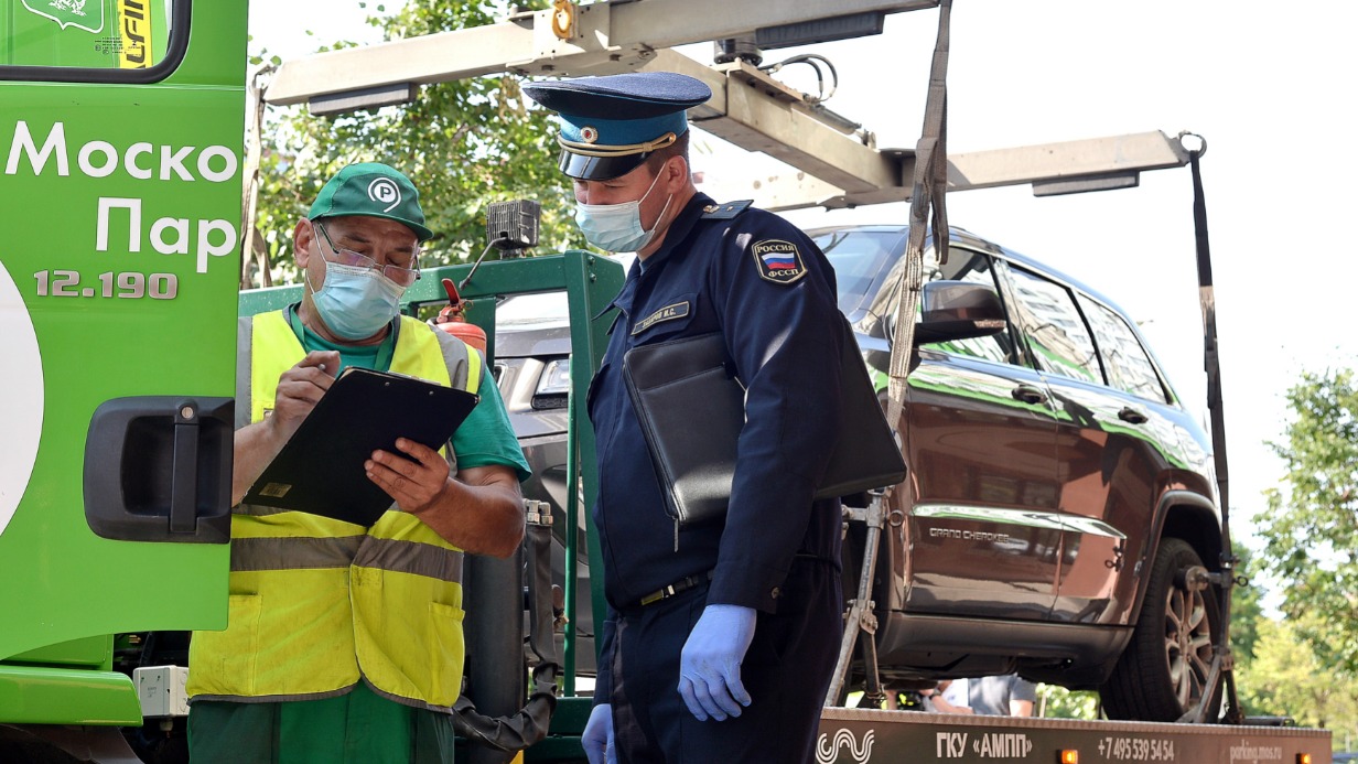 Судебный пристав Иван Захаров и представитель АМПП Борис Резцов изымают иномарку за долги. Владелец машины не оплатил штрафы на сумму 415 тысяч рублей