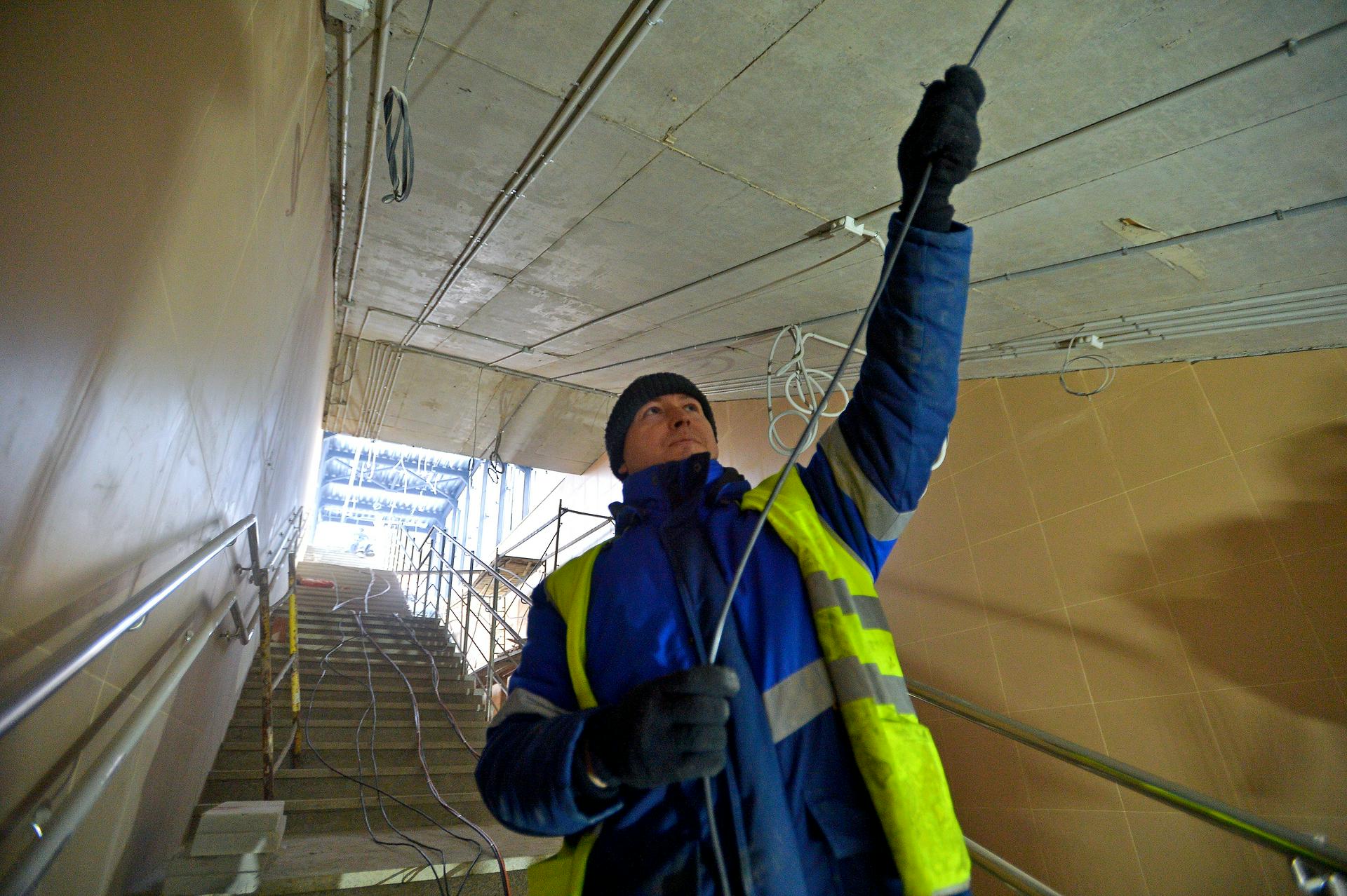 Электромонтажник Иван Панкратов протягивает кабель во время строительных работ на станции «Минская» МЦД-4