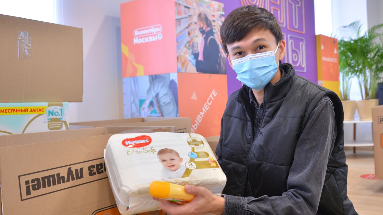 Доброволец Виктор Кутняков в штабе по сбору гуманитарной помощи для беженцев из ДНР и ЛНР принимает товары для детей