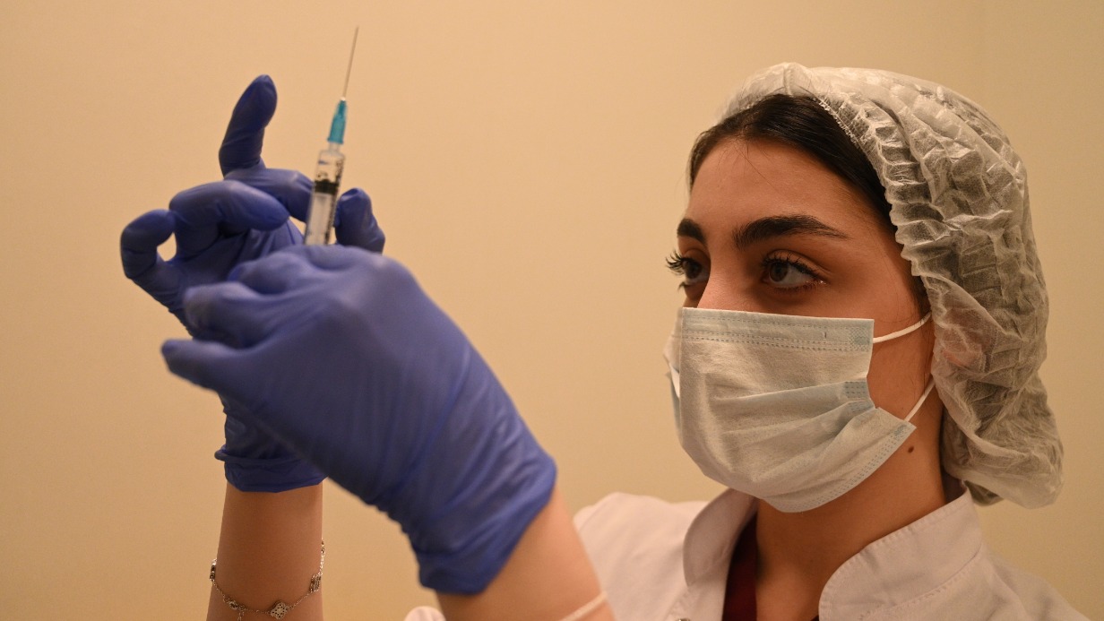 Московская медсестра Марела Оганесян собирается сделать прививку от COVID-19 пациенту в пункте вакцинации