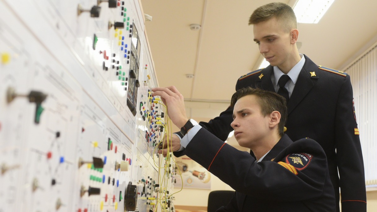 Курсанты 3-го курса Московского университета МВД России имени В. Я. Кикотя Анатолий Антонов (на переднем плане) и Василий Ломакин показывают абитуриентам, как работает лаборатория электрорадиотехнических измерений