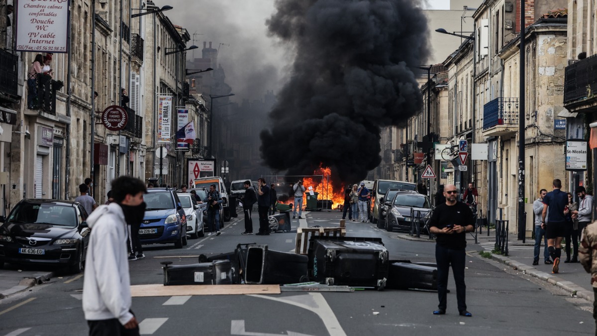 Протестующие выстроили баррикады из мусорных контейнеров посреди улицы в Париже. Французы уже месяц устраивают забастовки против пенсионной реформы
