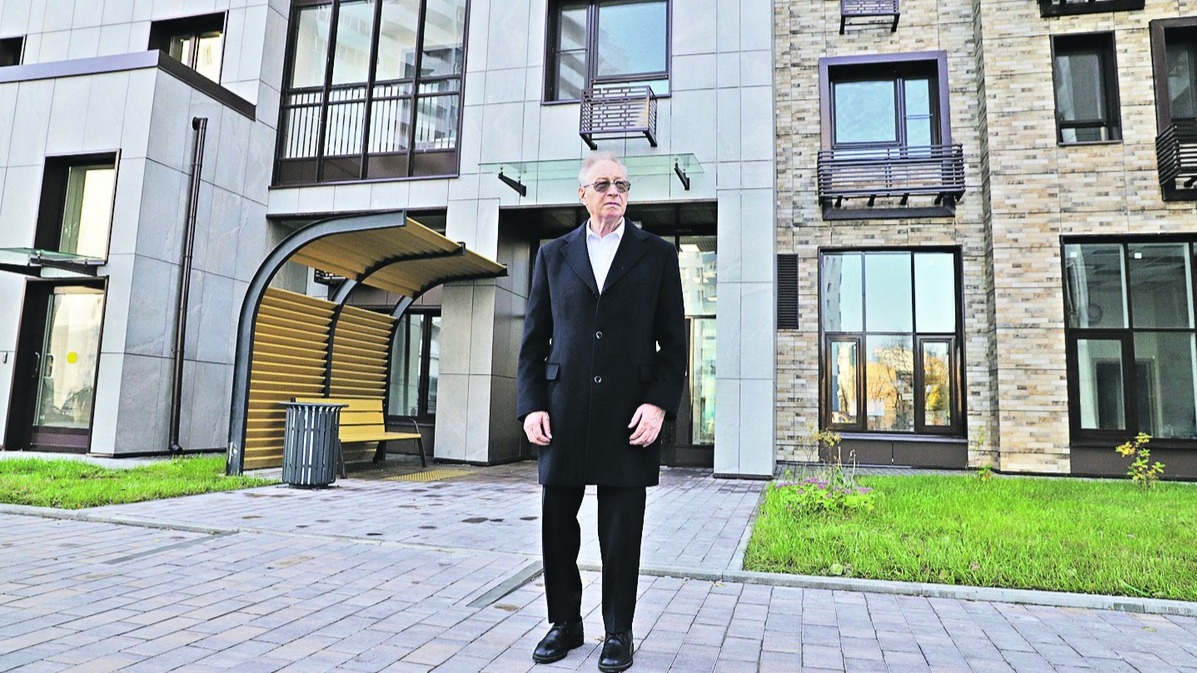 Валерий Теличенко на фоне нового жилого дома, построенного по программе реновации на улице Судостроительная, 15