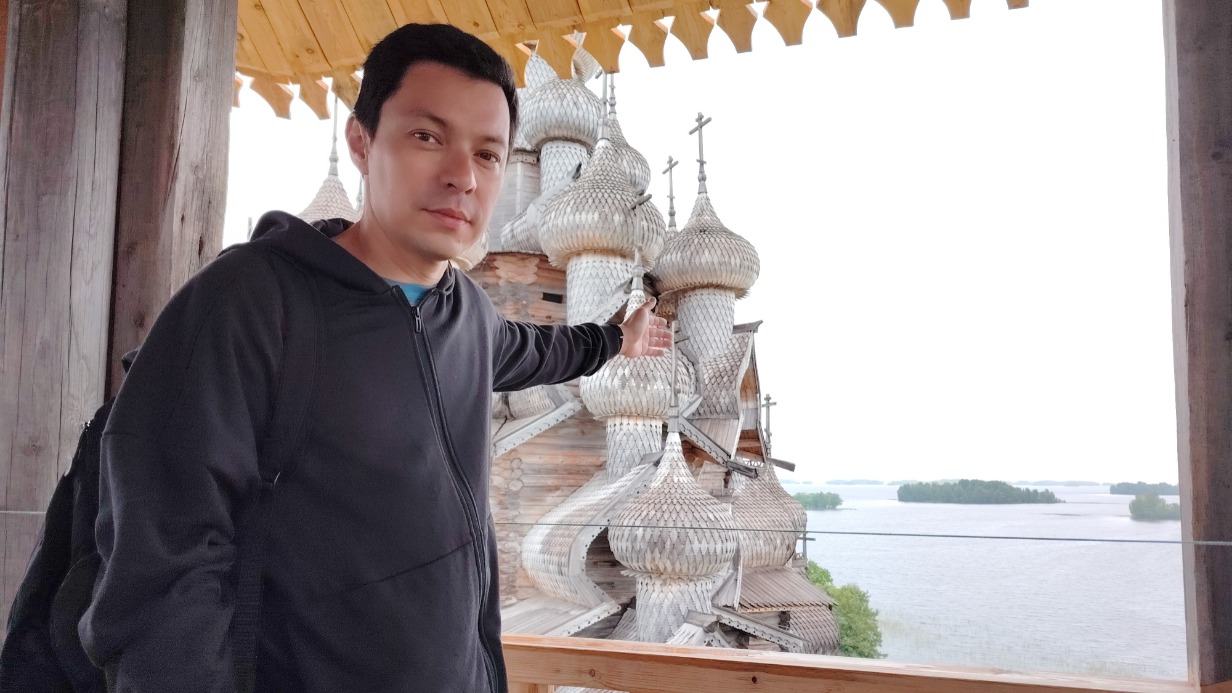 Начальник службы информации музея-заповедника «Кижи» Дмитрий Дюгай с колокольни показывает, какой открывается вид на Преображенскую церковь
