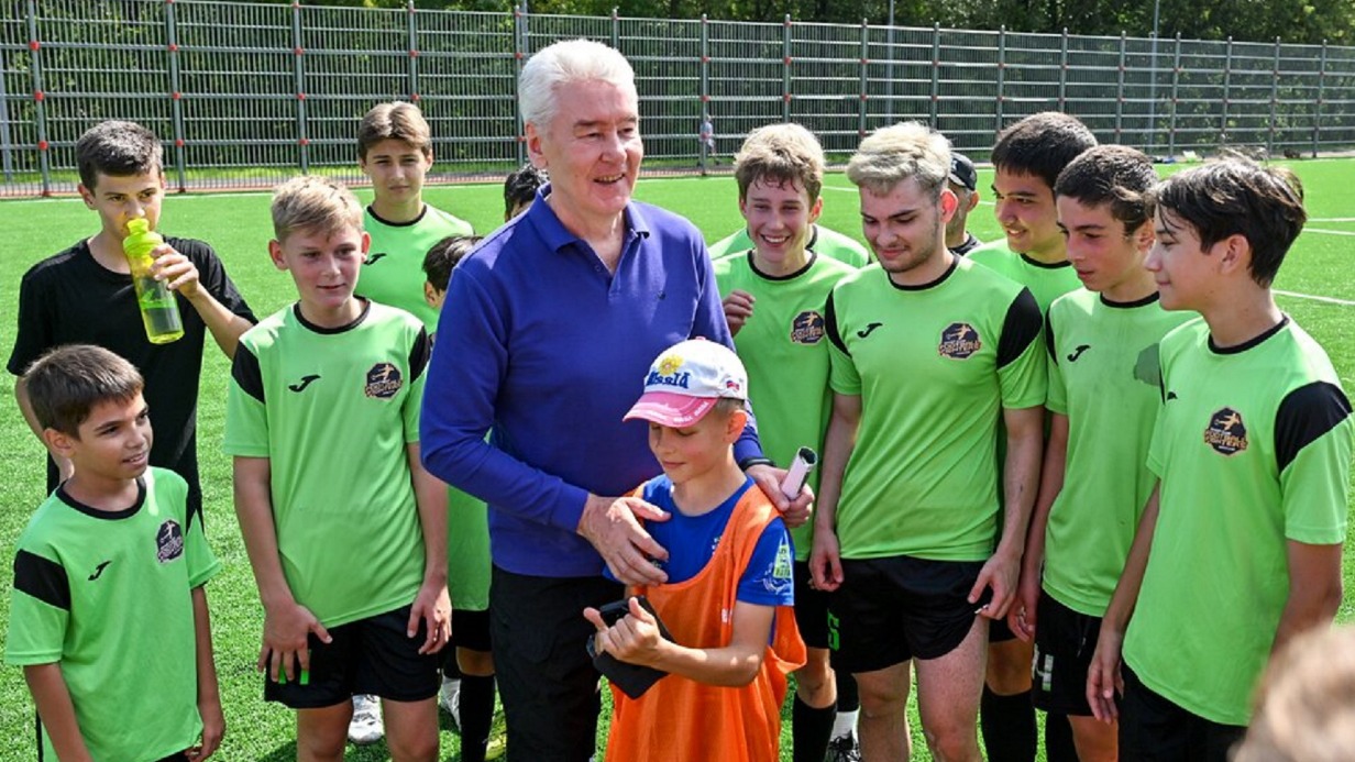 Мэр Москвы Сергей Собянин (в центре) с юными спортсменами на футбольном поле в пойме реки Котловка