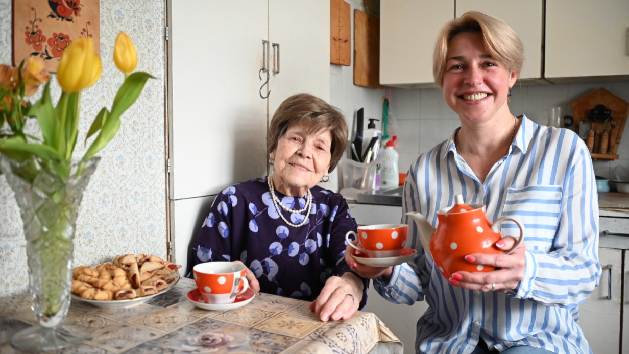 Социальный помощник Марина Анатольевна Чигитова пьет чай и обсуждает новости со своей 98-летней подопечной, ветераном труда Надеждой Минаевой, которая находится на надомном обслуживании уже более десяти лет