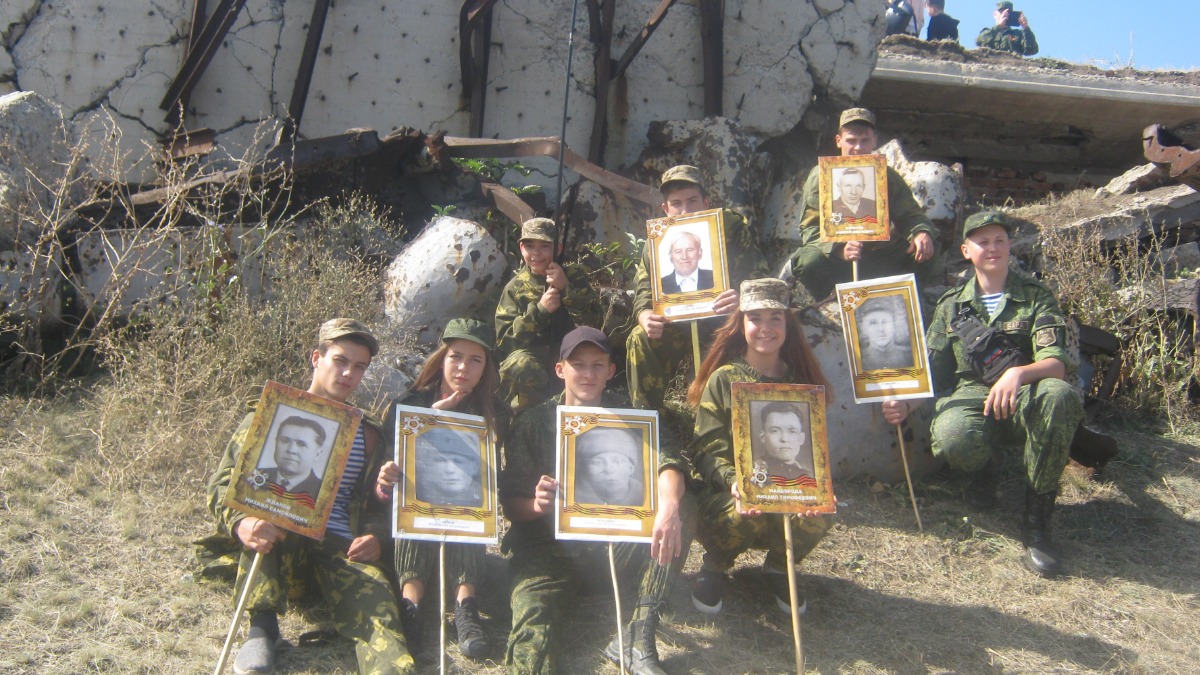 Воспитанники Казачьего военно-патриотического клуба «Ермак» участвуют в акции «Бессмертный полк» на кургане Саур-Могила. Четверо участников этой фотографии сегодня защищают свой родной край на полях спецоперации