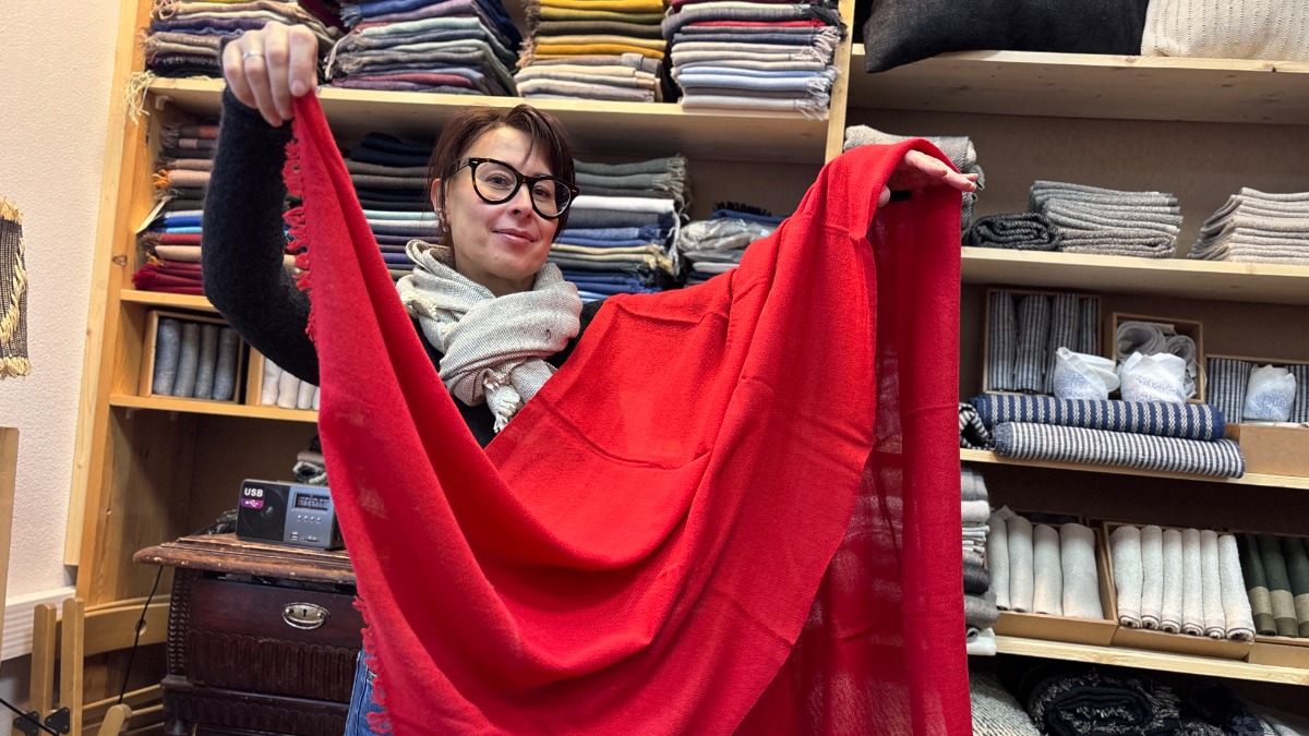 Соучредитель текстильного предприятия Елена Александрова показывает одну из ярких шалей, сотканных вручную